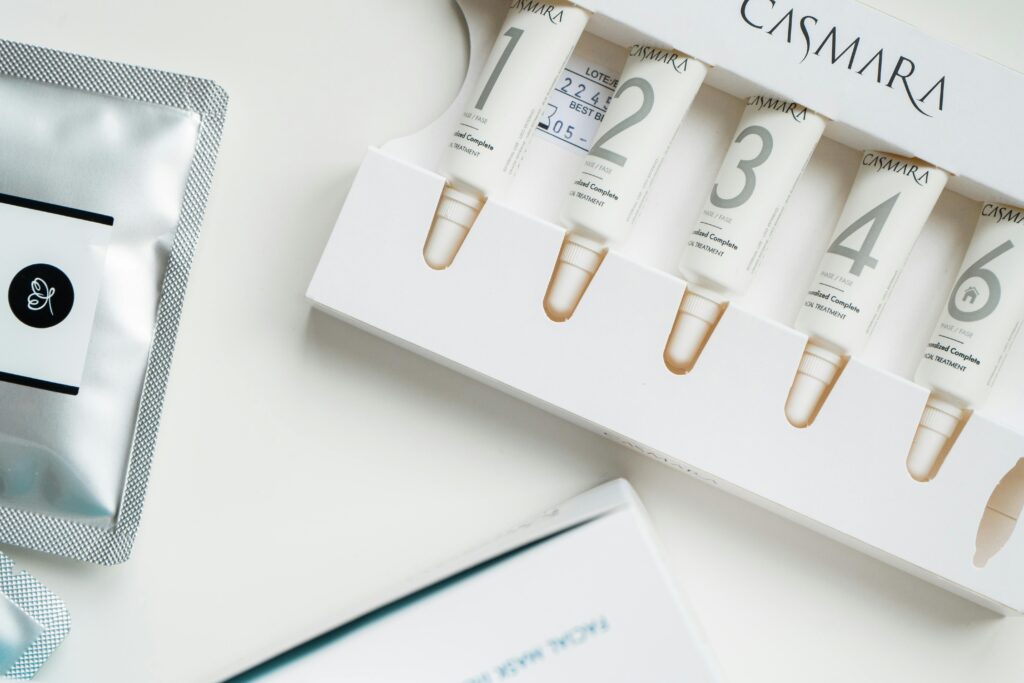 High-angle shot of Casmara beauty products in sleek packaging on a white surface.