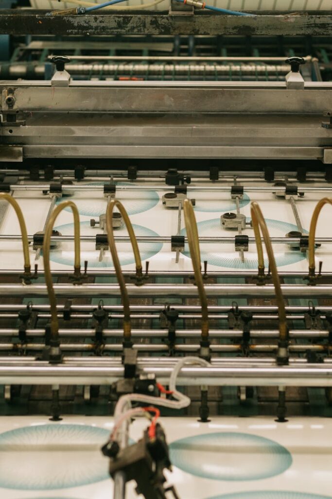 Close-up of an industrial printing press producing designs.