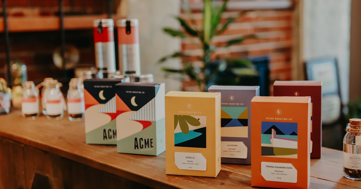 A variety of vibrant coffee packages displayed on a wooden counter in a cozy cafe setting.