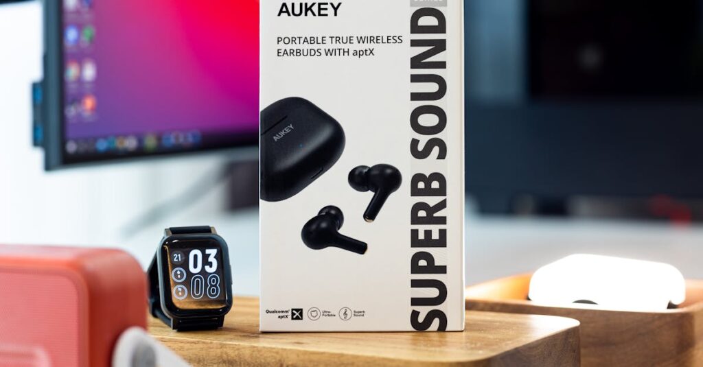 AUKEY wireless earbuds and smart watch showcased on a modern desk setup.
