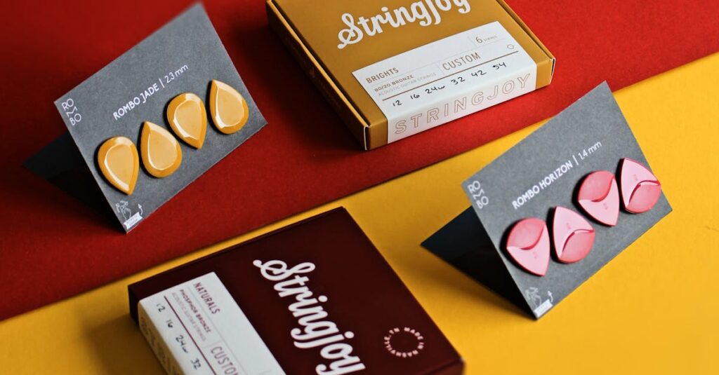A vibrant flat lay of guitar picks and packaged string sets on red and yellow background.