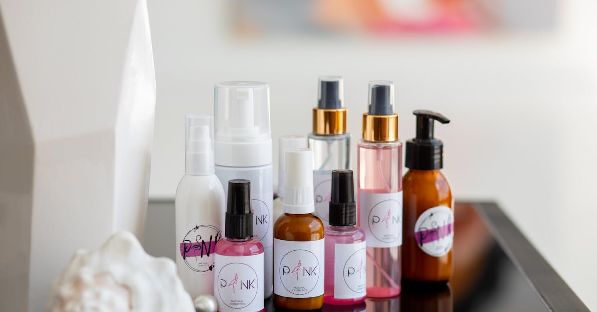 Collection of diverse skincare bottles arranged stylishly on a reflective surface, ideal for beauty concepts.