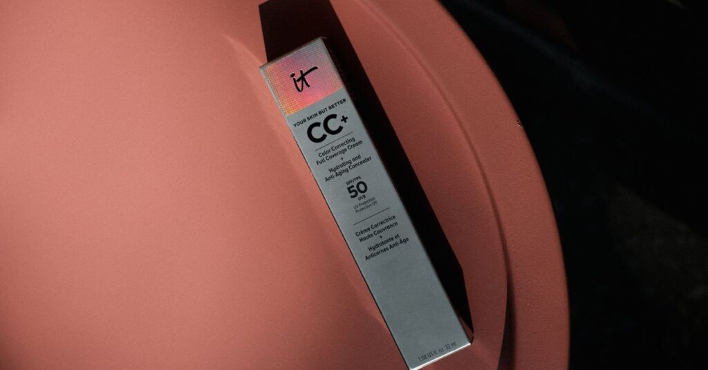 Elegant packaging of a CC+ cream with SPF 50 on a modern, colored table.