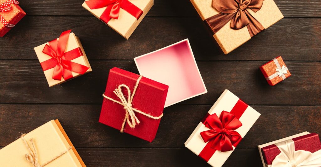 A festive flat lay of various Christmas presents adorned with colorful ribbons on a wooden background.
