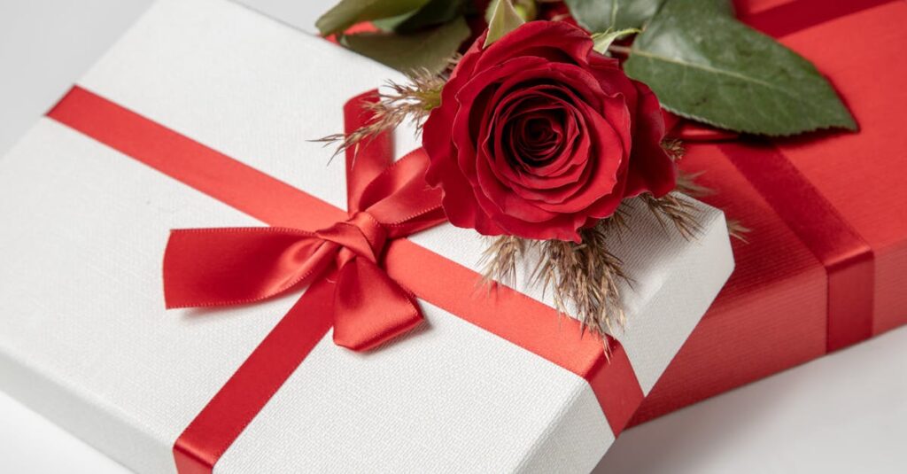 Close-up of beautifully wrapped gift boxes with a red rose, perfect for romantic occasions.