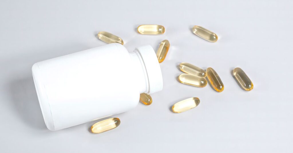 Healthy fish oil capsules spilled from a white bottle on a smooth white surface.