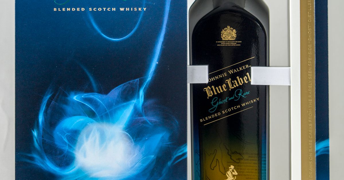 Johnnie Walker Blue Label whisky bottle with glass in elegant packaging.