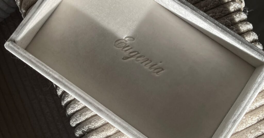 Elegant open velvet box with 'Eugenia' branding, perfect for jewelry packaging.