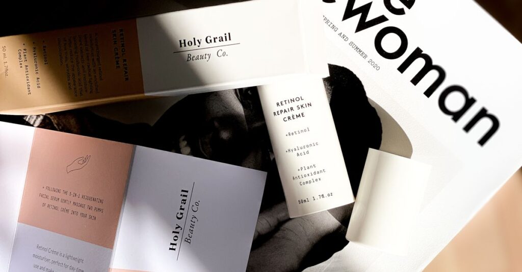 Top view of a magazine layout with beauty product advertisements in a bright and artistic setting.