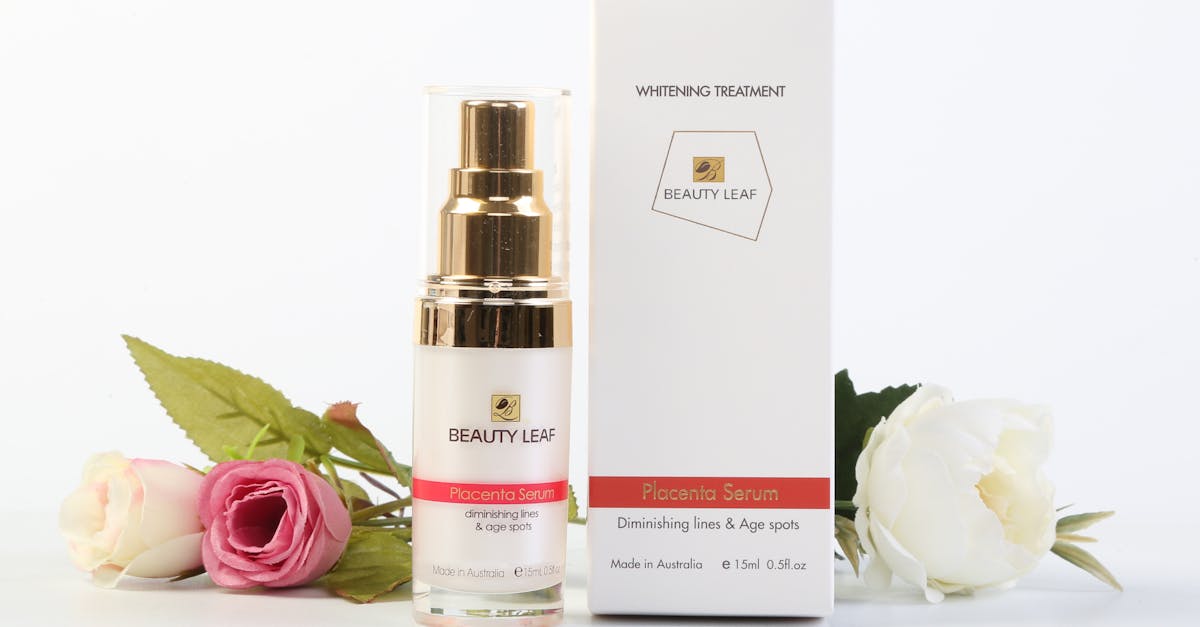 Elegantly arranged Beauty Leaf serum and box with roses on a crisp white backdrop.