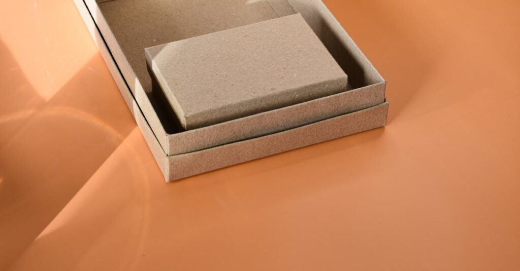 Close-up of a cardboard box on an orange surface, ideal for packaging themes.