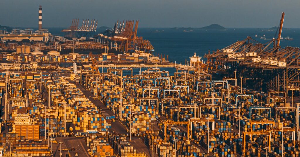 Aerial shot of Xiamen's bustling port with stacked shipping containers and cranes.