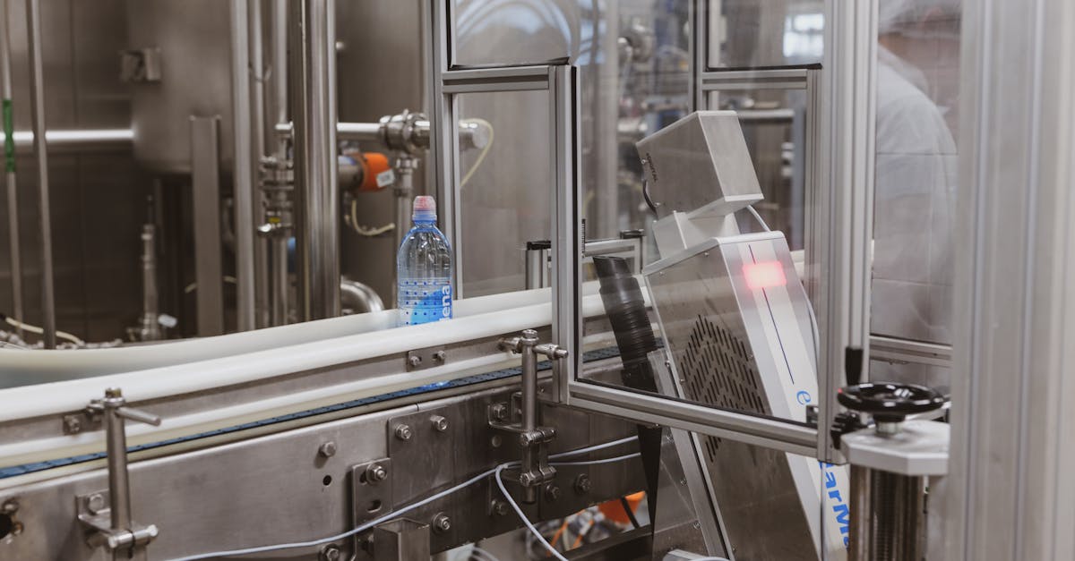 Close-up of a plastic bottle in a modern factory bottling production line.