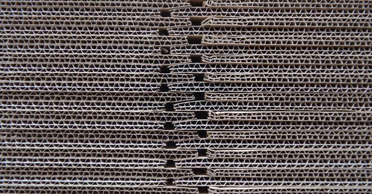 Detailed close-up of corrugated cardboard stack showcasing its wavy texture and pattern.