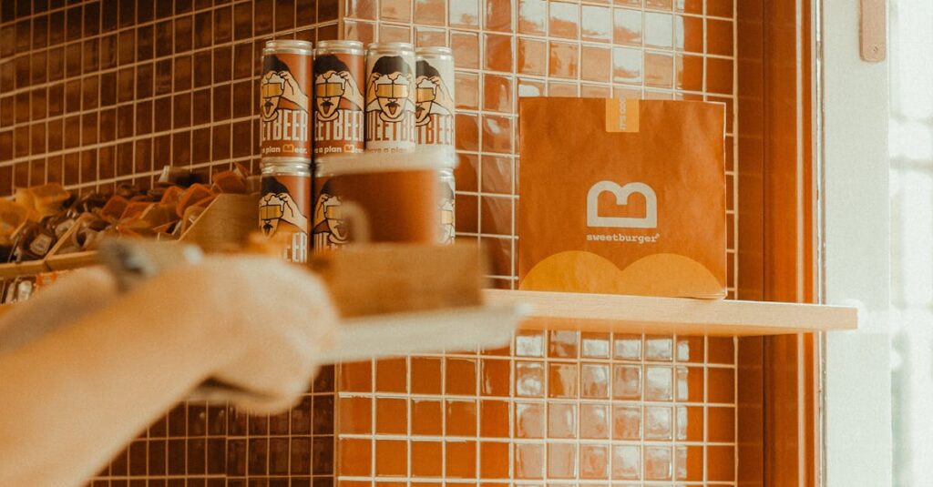 A warm-toned coffee shop with orange tiled walls and packaged goods on shelves.