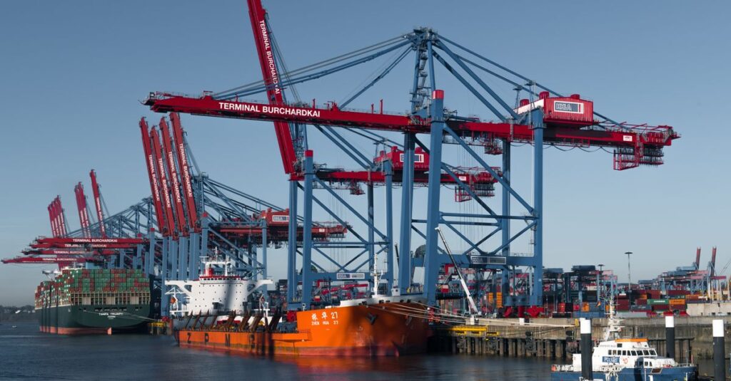 Container ships docked at Hamburg's busy Terminal Burchardkai under cranes.