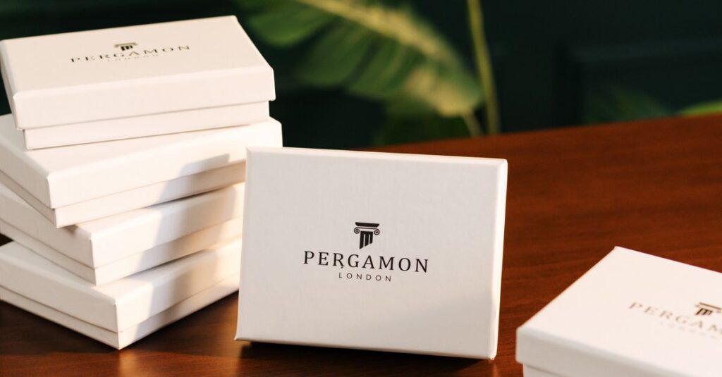Stylish Pergamon London gift boxes arranged on a wooden table, creating a luxurious and elegant atmosphere.