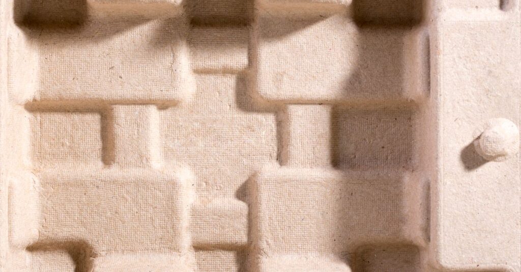 Detailed overhead view of textured cardboard packaging insert for protection.