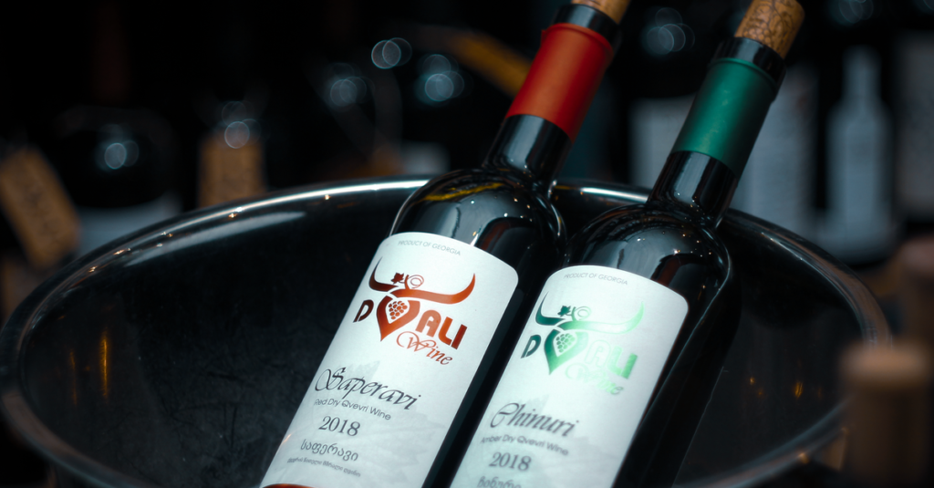 Two wine bottles with corks in ice bucket, perfect for wine tasting and events.