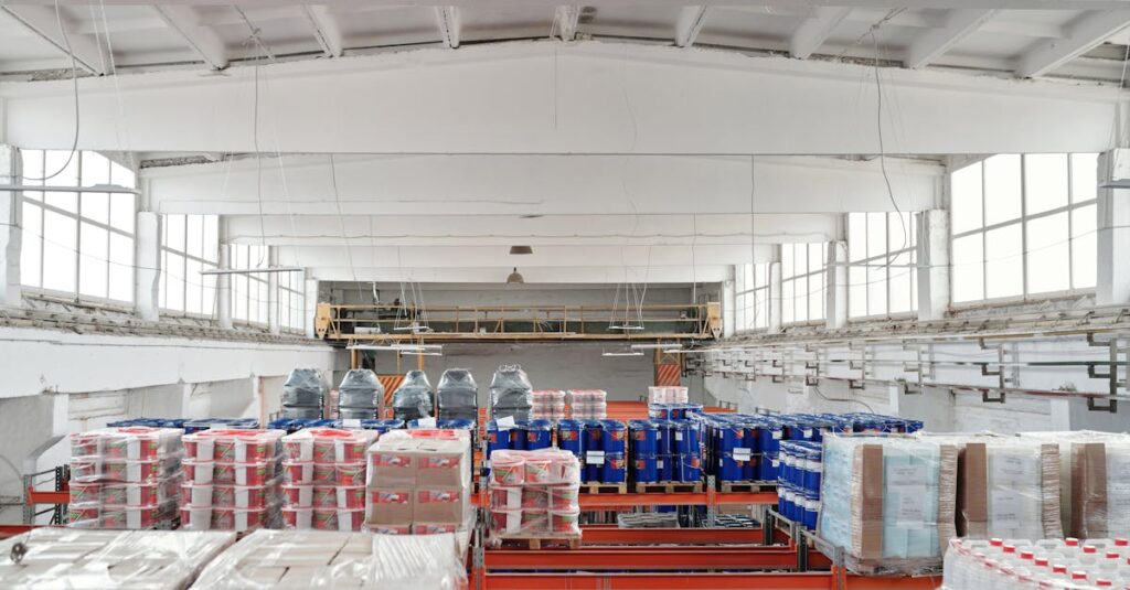Spacious warehouse interior featuring organized shelves with various stacked pallets.