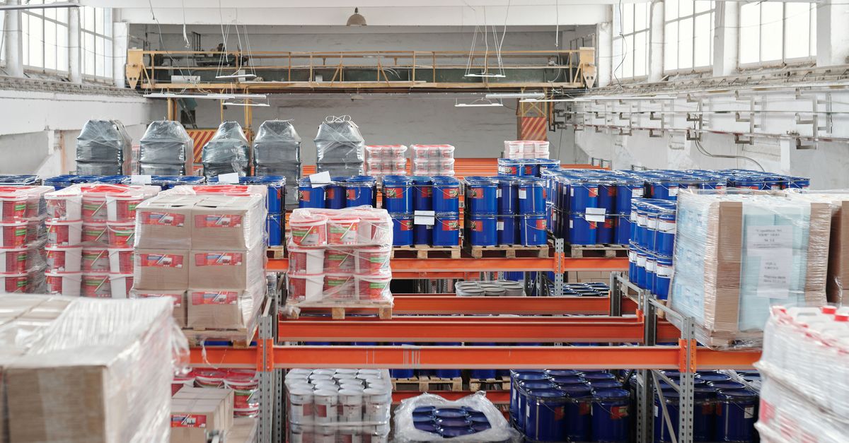 Interior of a large warehouse with neatly organized goods on shelves, ready for shipment.