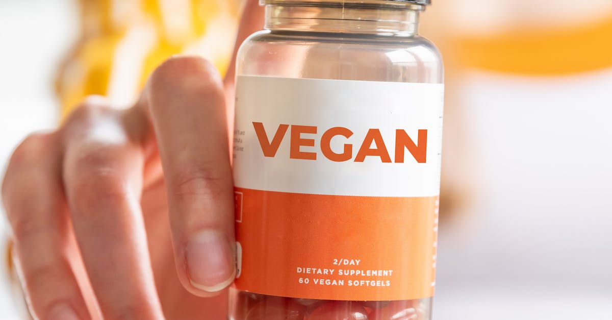 A detailed image of a hand holding a vegan supplement bottle, ideal for health and lifestyle themes.
