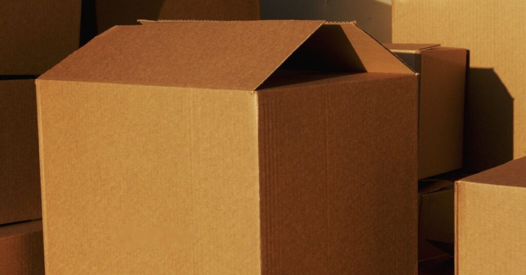 Stacked cardboard boxes ready for shipping or storage in a warehouse setting.