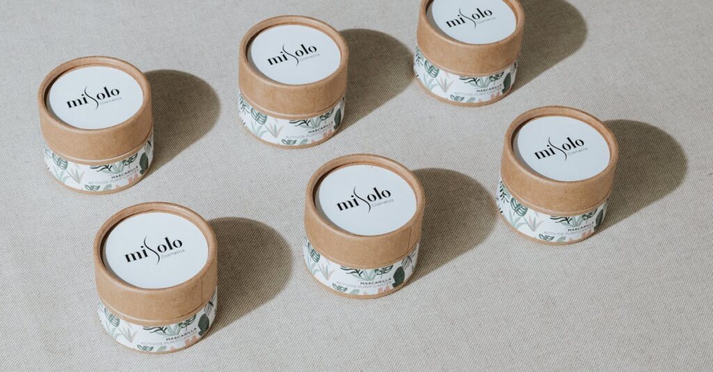 Six eco-friendly cosmetic containers arranged for a minimalist product display.