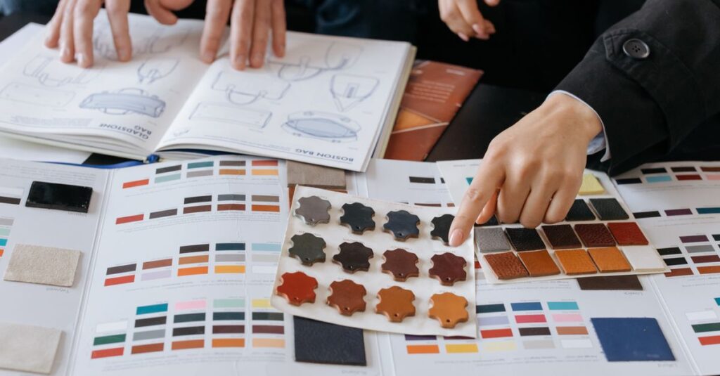 Designers reviewing color swatches and sketches for project planning.