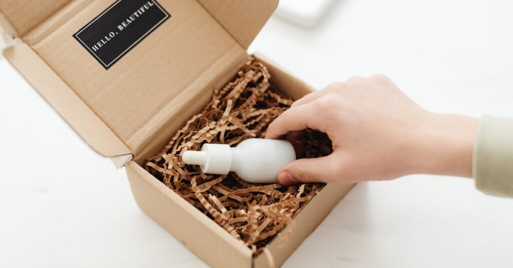 A hand unboxes a beauty product in a sustainable cardboard package with shredded paper.