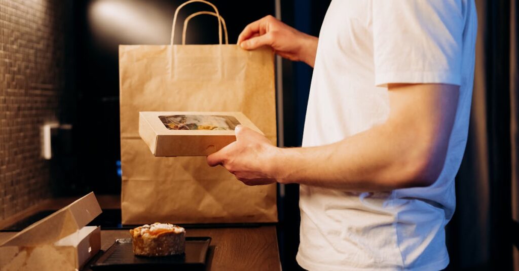 Man unpacking a food delivery bag in a modern kitchen. Ideal for lifestyle or delivery themes.