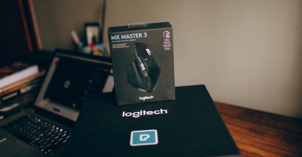 Image of Logitech MX Master 3 wireless mouse box on a desk with a blurred laptop in background.