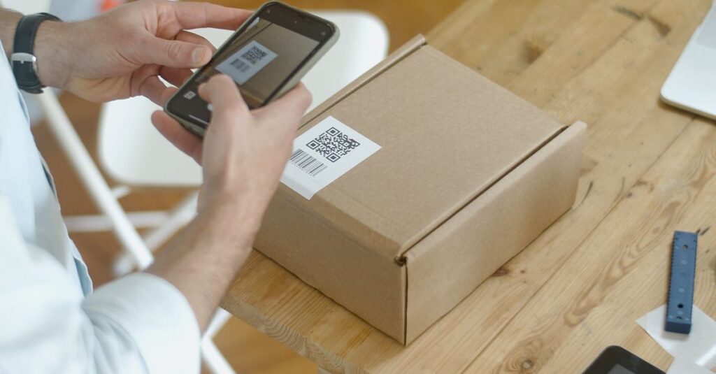A person uses a smartphone to scan a QR code on a package in an online store setting.