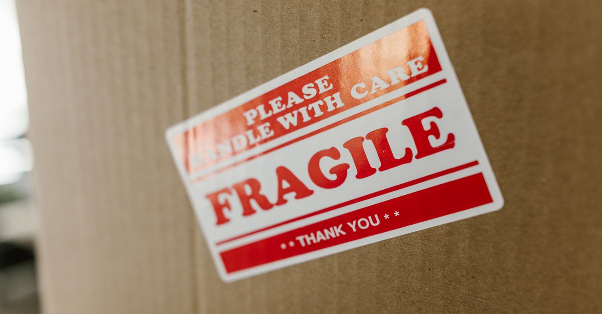 Close-up of a cardboard box with a 'fragile' sticker indicating careful handling.