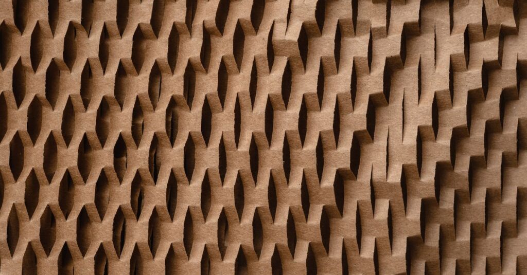 Close-up of a textured honeycomb pattern paper, showcasing geometric design and craft elements.