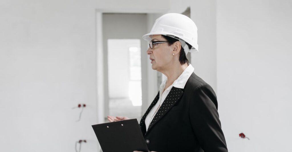 Professional female engineer inspecting a construction site with clipboard and helmet.