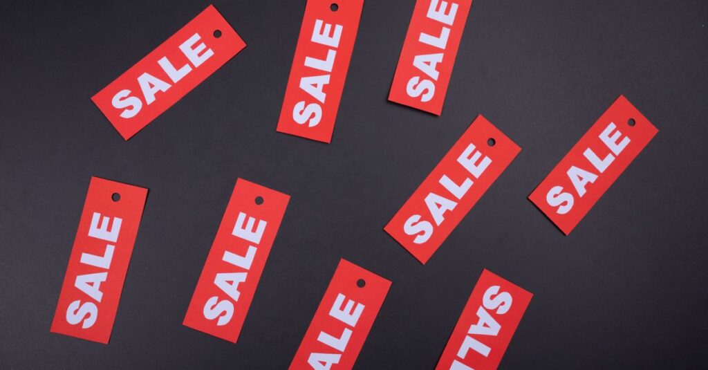 Red sale tags on a black background. Ideal for marketing and promotional use.