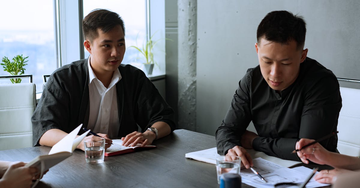 Group of professionals discussing business strategies in a modern office setting.