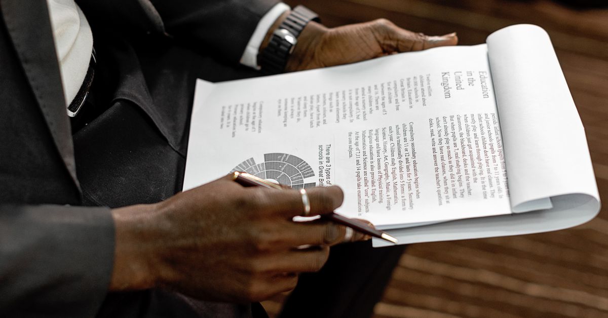 Business professional reviewing financial documents with charts and graphs during a meeting.