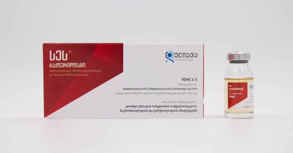 Close-up of medicine box and vial with Georgian text on a white background.