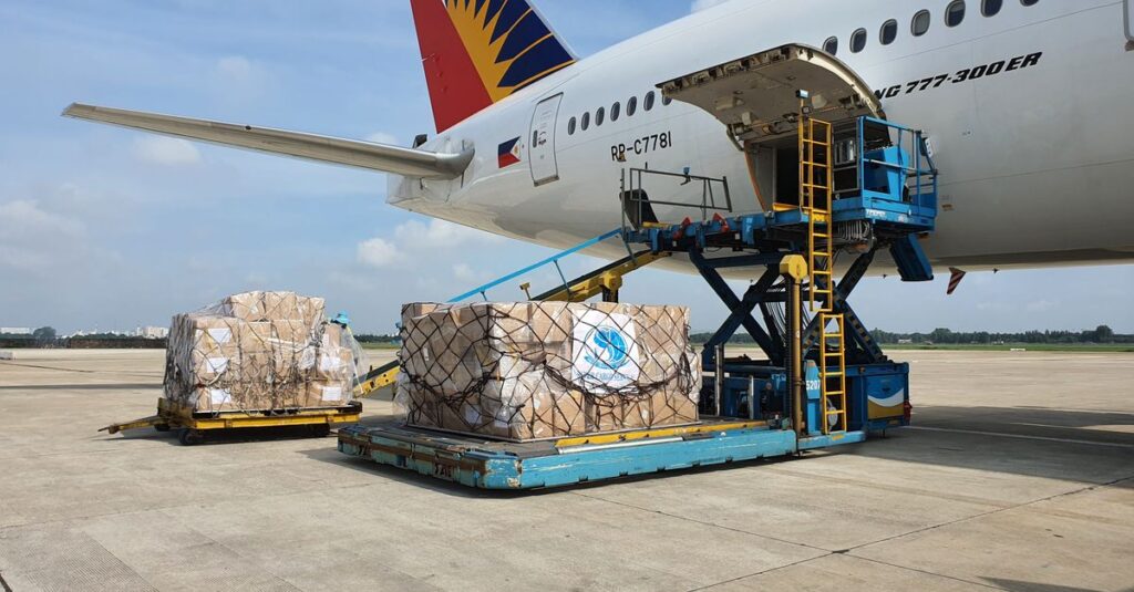 Cargo being loaded onto a commercial airplane at an airport in Ho Chi Minh City, Vietnam.