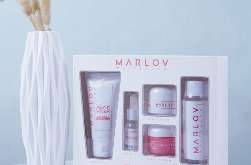 Minimalist skincare set displayed with a decorative vase, promoting beauty and wellness.